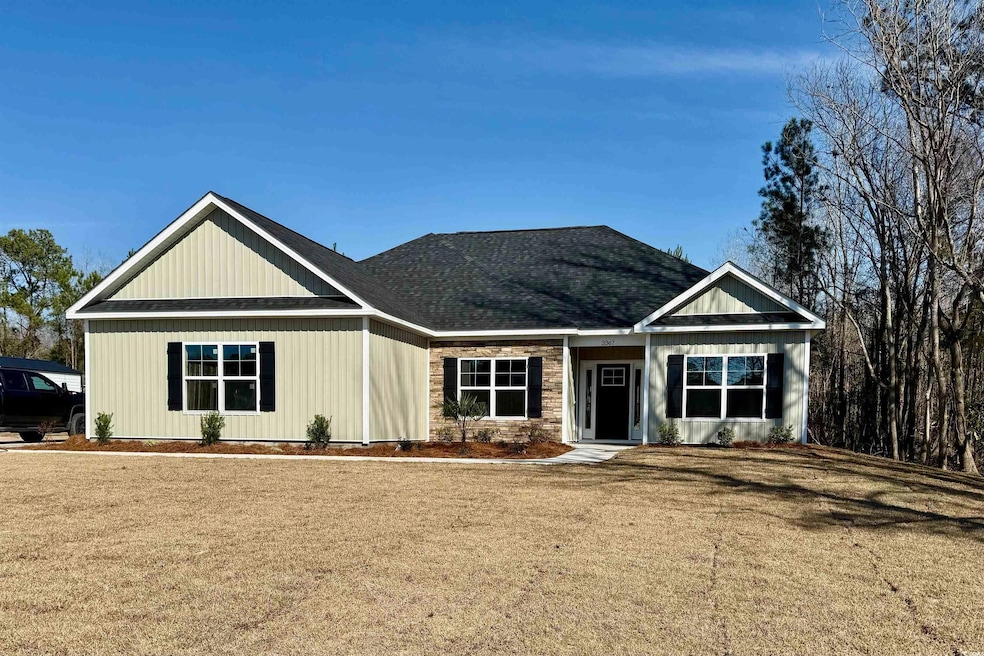 View of front of home with a front yard and roof w