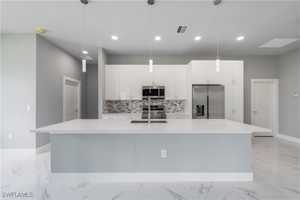 Kitchen with appliances with stainless steel finis