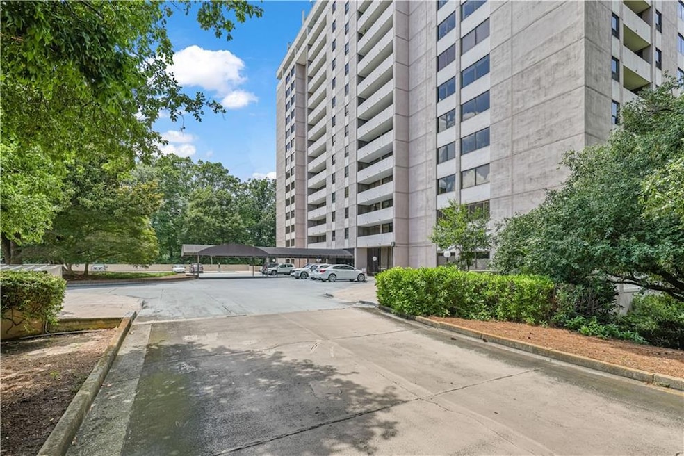 View of property with covered and uncovered parking
