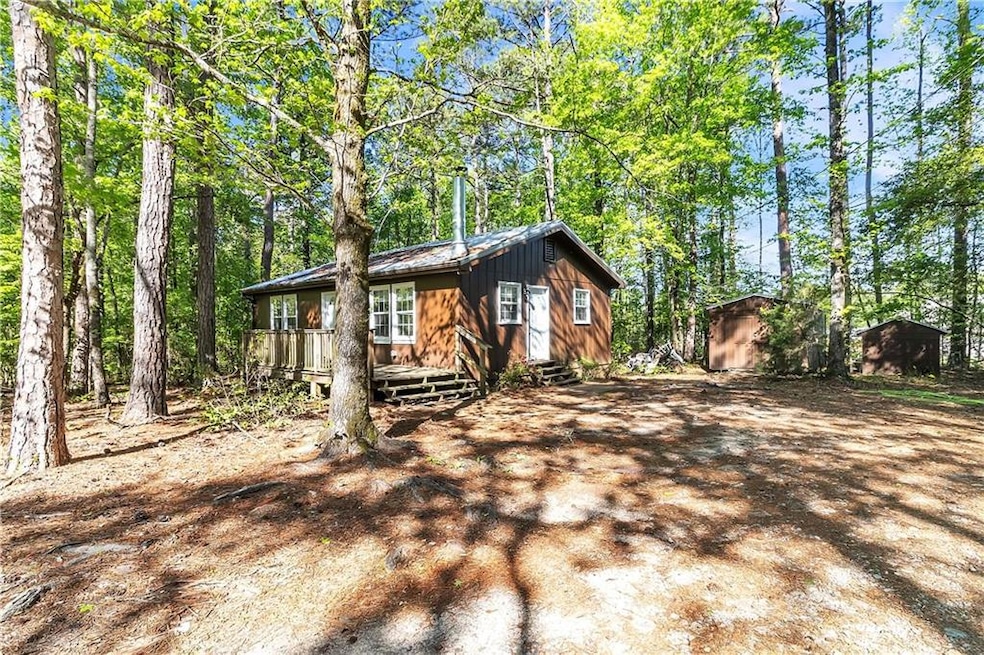 View of front of property with a storage shed, an 