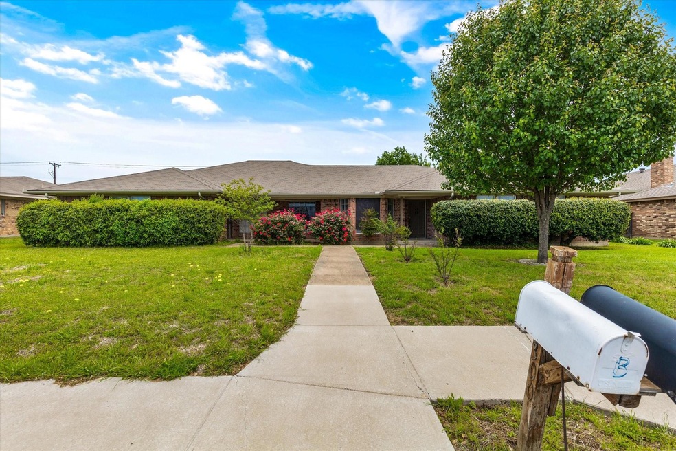 Ranch-style home featuring a front lawn