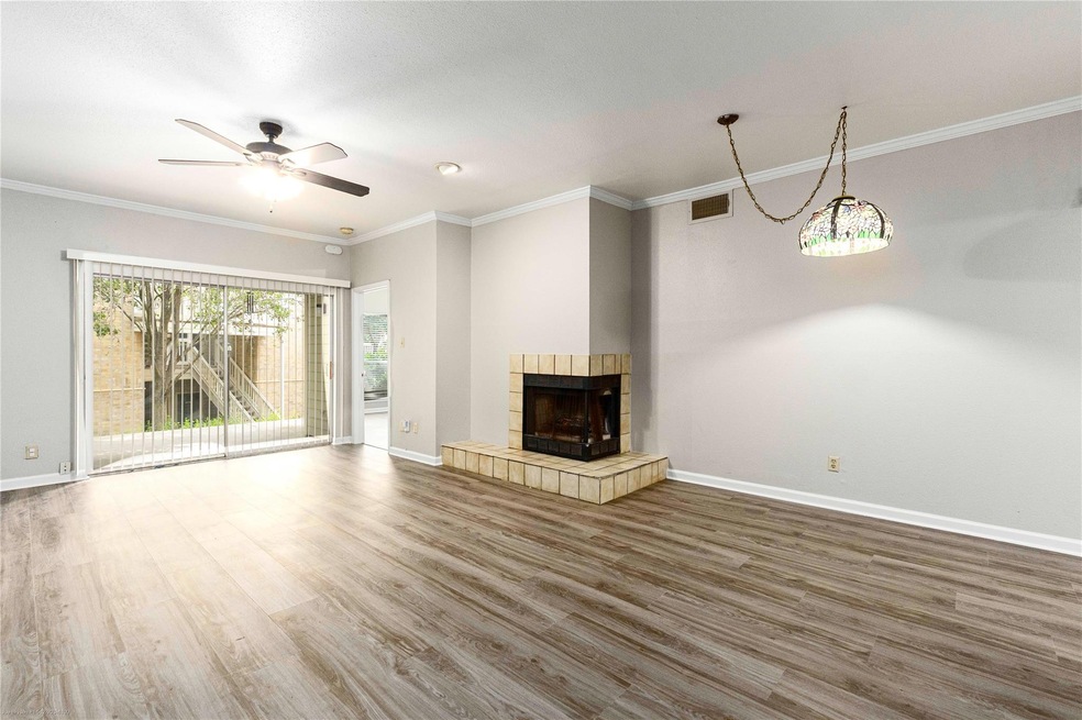 Unfurnished living room with baseboards, wood fin