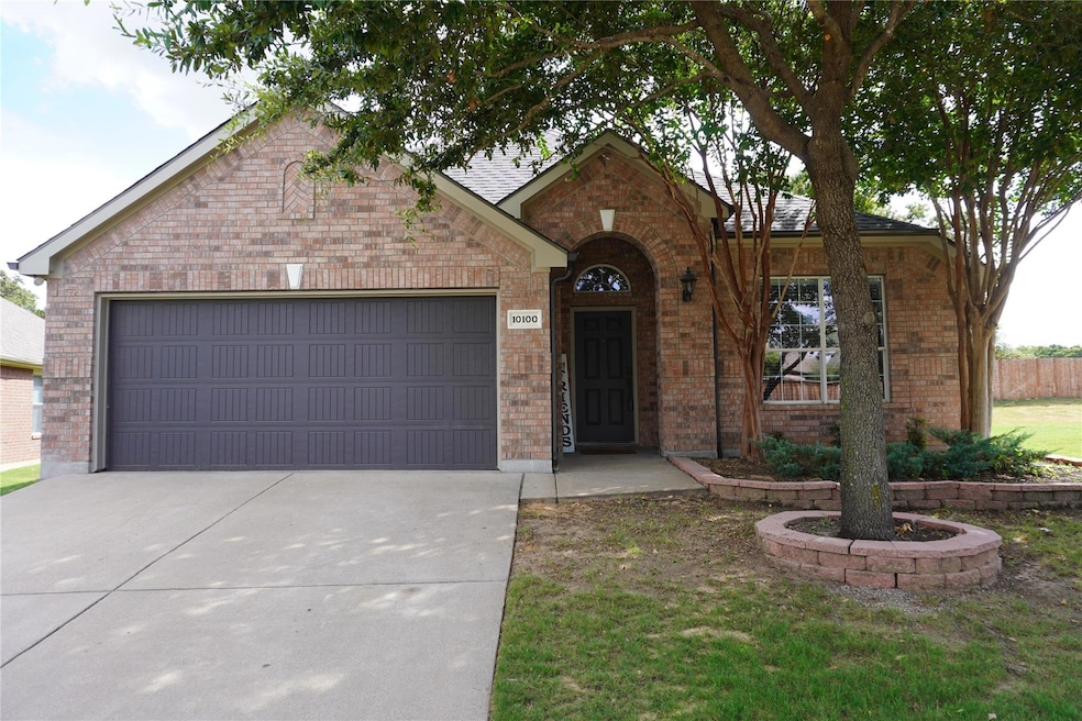 View of front facade with a garage and a front lawn