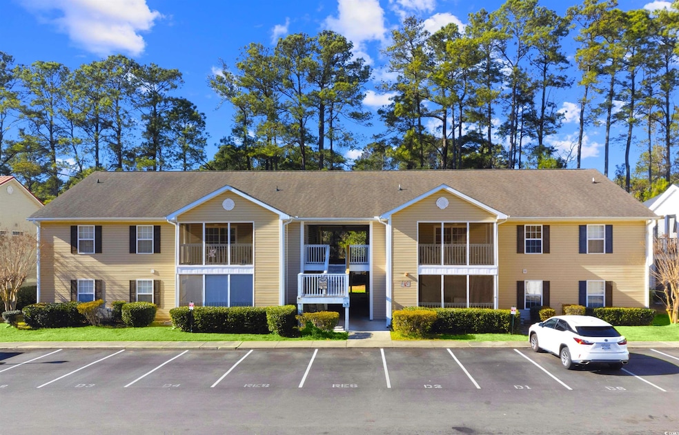 View of building exterior with uncovered parking