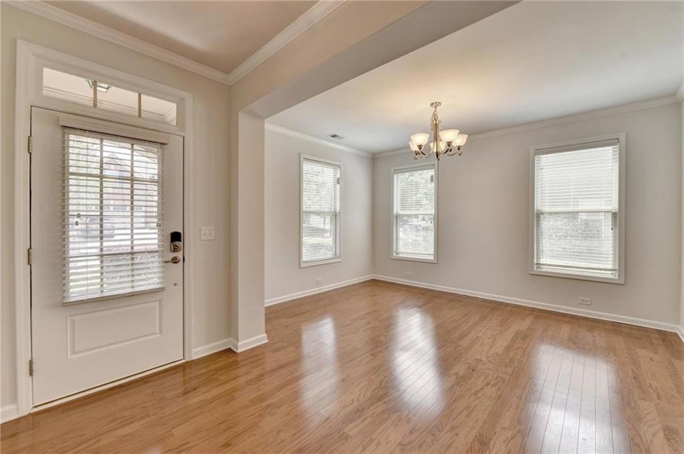 Entryway featuring light hardwood / wood-style floors, ornamental molding, and an inviting chandelier