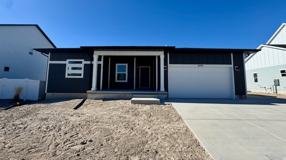 View of front of house featuring board and batten siding, a porch, an attached garage, and driveway