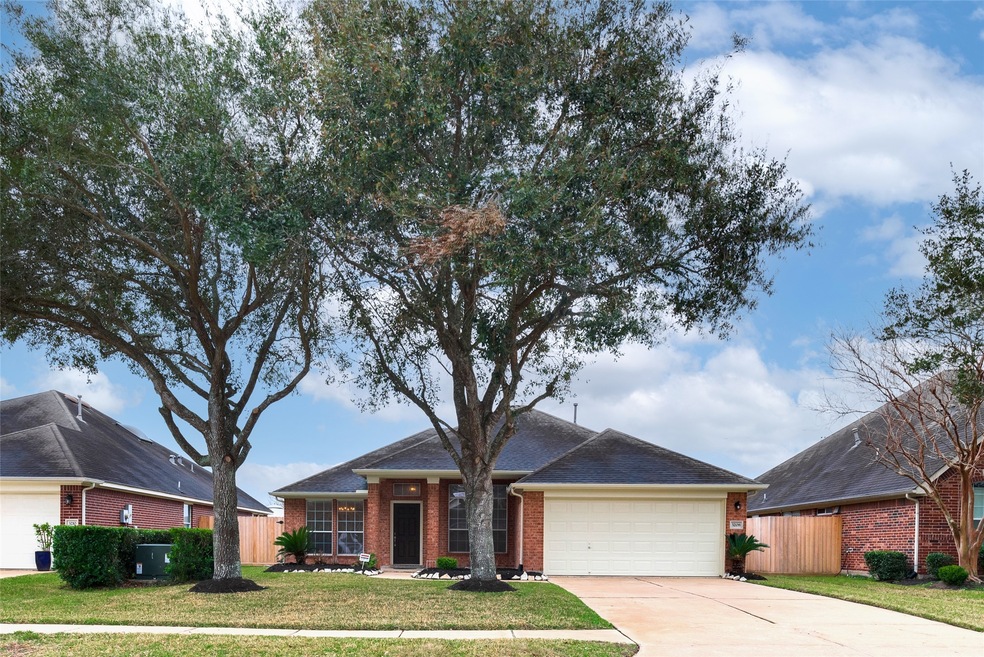 Lovely trees and a welcoming front porch greet you as you approach 3208 Keithwood Drive.