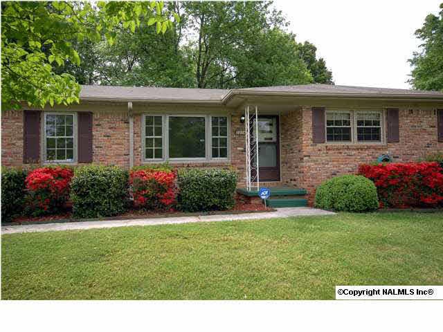 Brick home in quiet neighborhood. Azalea bushes bloom in the spring and say 