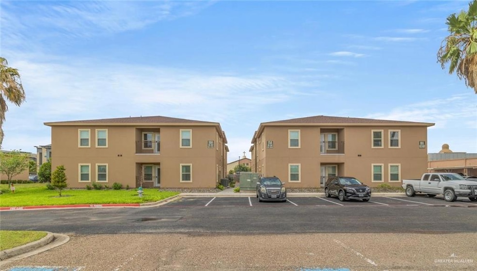 View of property featuring uncovered parking