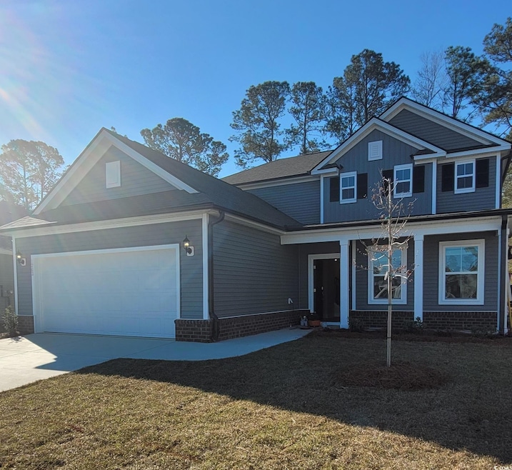 View of front of house featuring concrete driveway