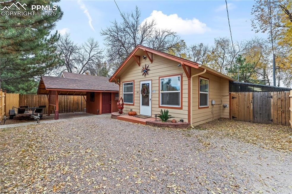 View of front of house with driveway and a shingled roof