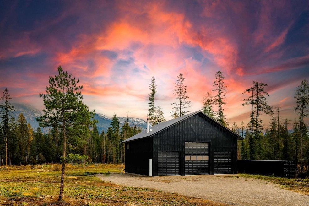 Outdoor structure at dusk featuring a view of trees