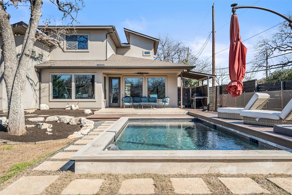 Back of property featuring stucco siding, an outd
