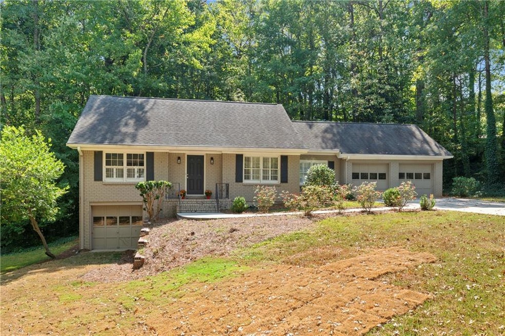 View of front facade featuring a porch, a garage, 