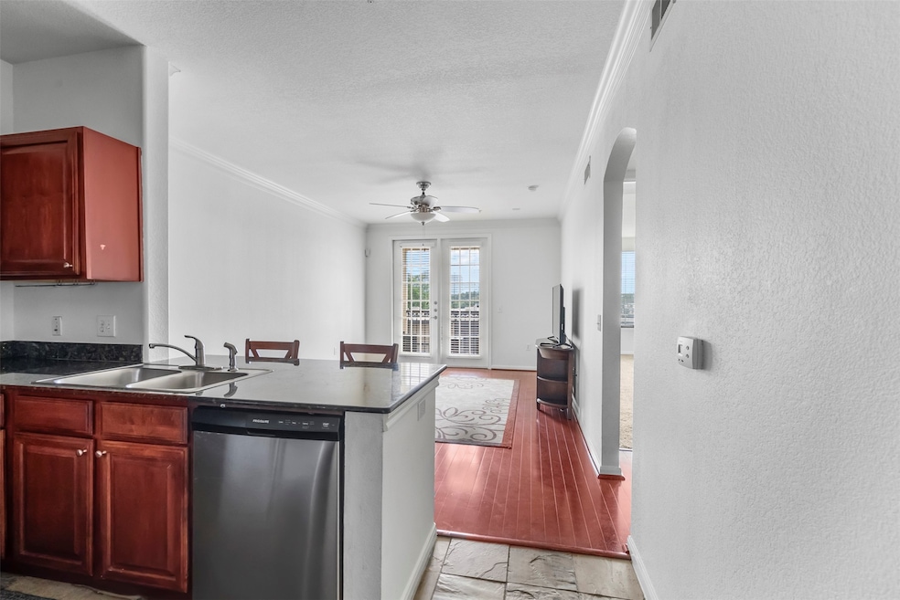 Front door opens to kitchen with living room beyon