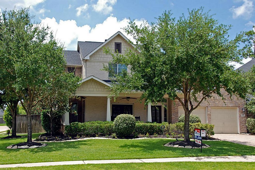 Situated on spectacular corner lot framed by live oak trees!