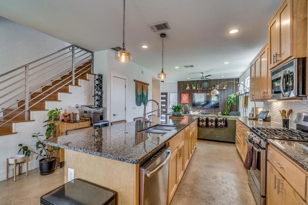 Kitchen with visible vents, a ceiling fan, a sink