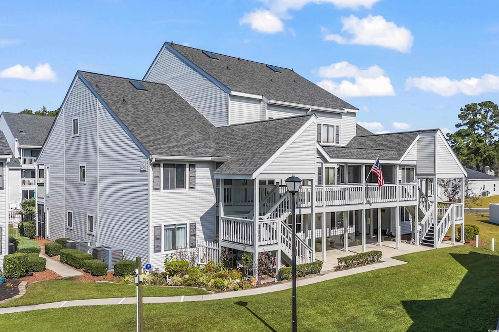 Back of house with a yard, a patio, and a wooden d