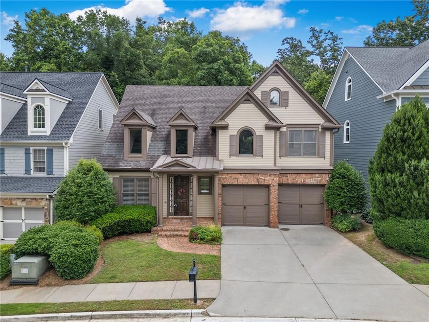 View of front of property with concrete driveway, an attached garage, brick siding, and a shingled roof