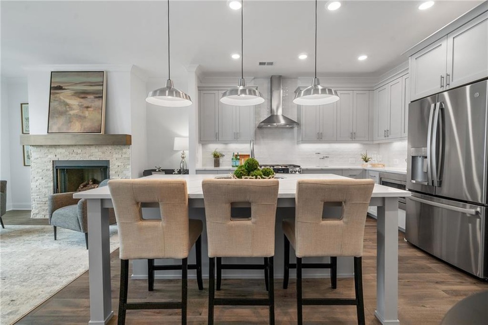 This open floor plan features a beautiful kitchen, stainless steel appliances, and large island that opens to family room. Photo not actual home, but previously built Garrison plan.
