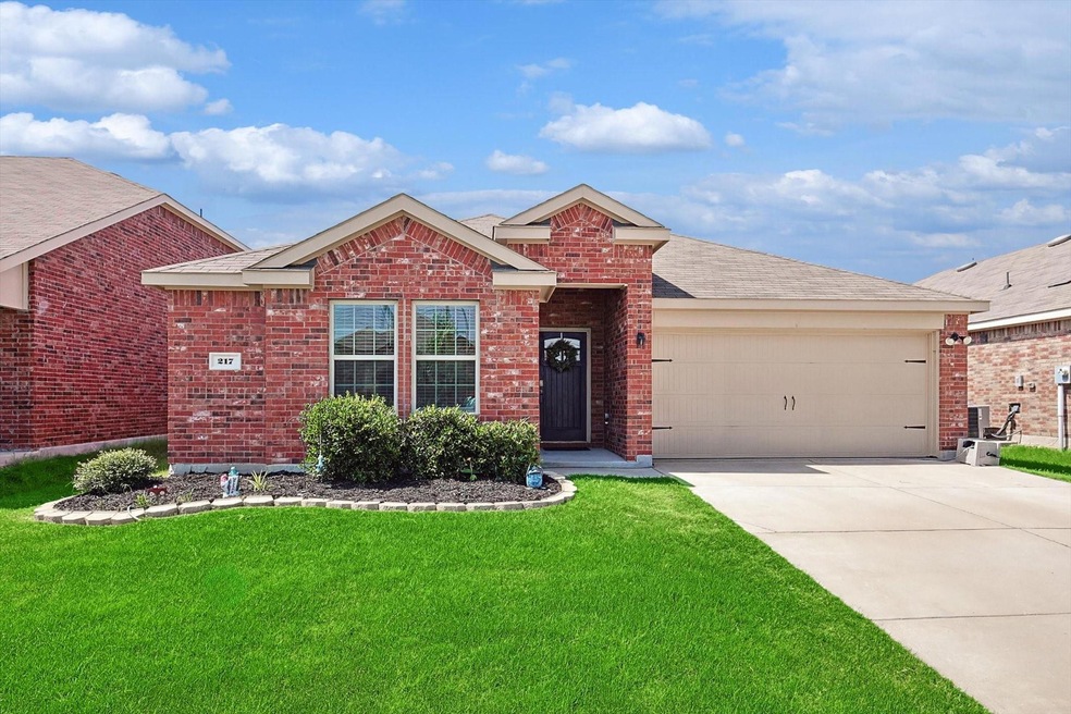 View of front facade with a garage and a front yar