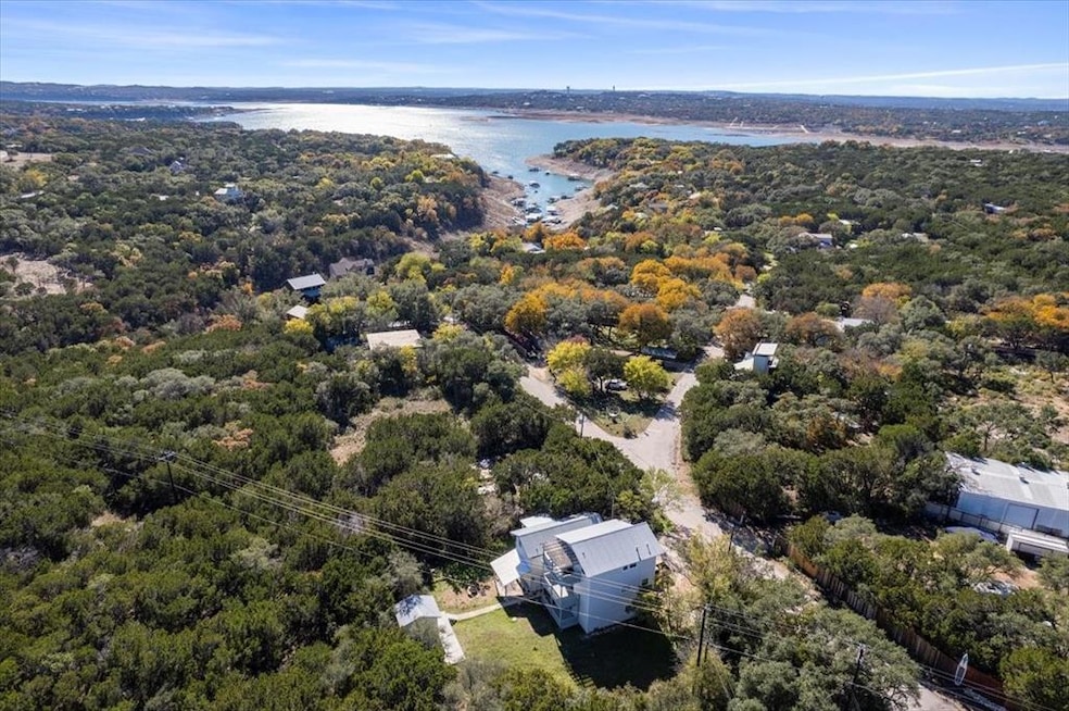 Birds eye view of property with a water view and 