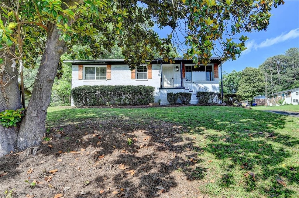 Single story home with a front yard and brick siding