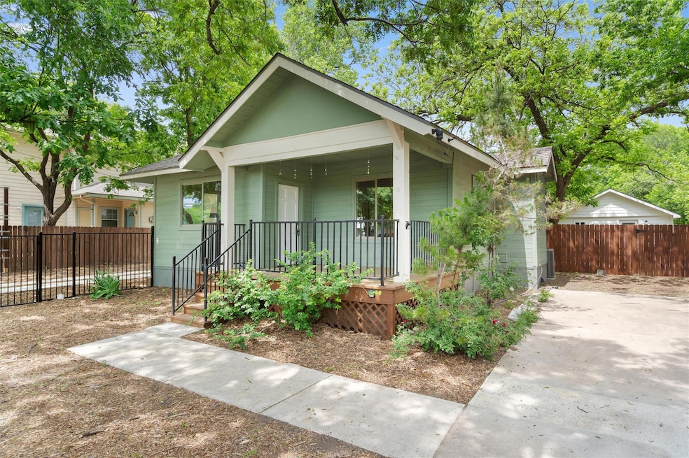 Bungalow featuring covered porch and fence
