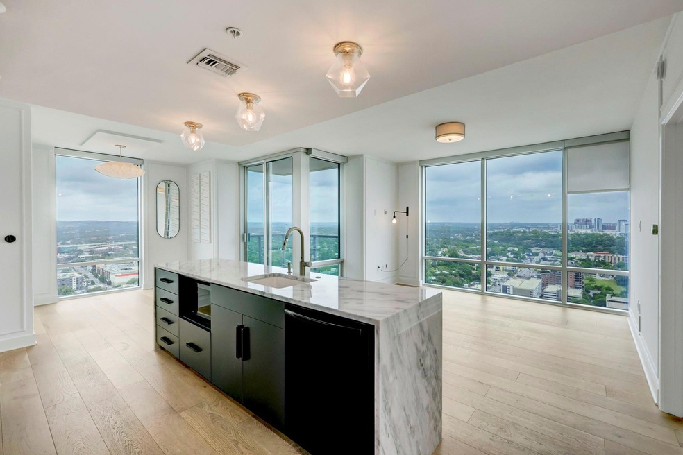 Kitchen with a sink, black dishwasher, a wall of 