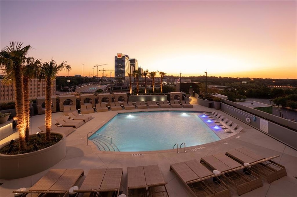 Pool at dusk featuring a patio