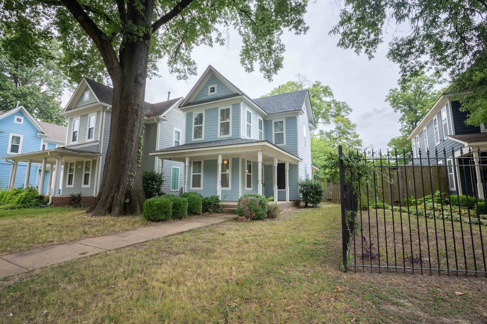 Victorian house featuring a front yard and covered