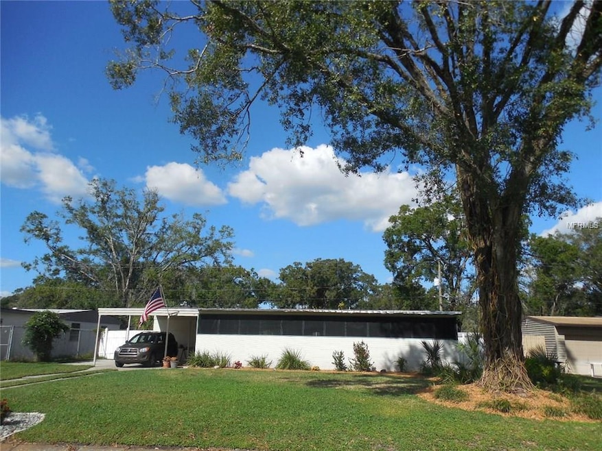 80' wide! No narrow lots here! Grandgather oak, 1 car carport with added parking space; screened room across front offers room to entertain and relax in both the front and back yard.