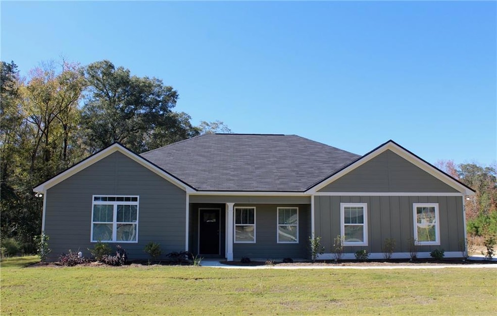 Ranch-style home featuring a front lawn, a porch, and board and batten siding