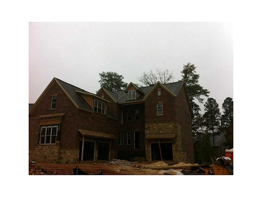 Exterior Front. Ashlar cut stone and brick cover t