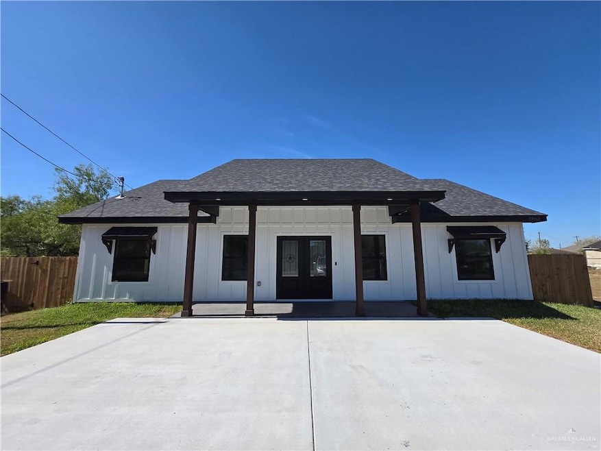 View of front of house featuring roof with shingles, covered porch, board and batten siding, and french doors
