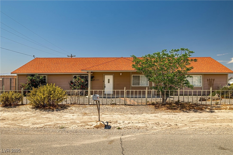 Ranch-style home featuring a fenced front yard
