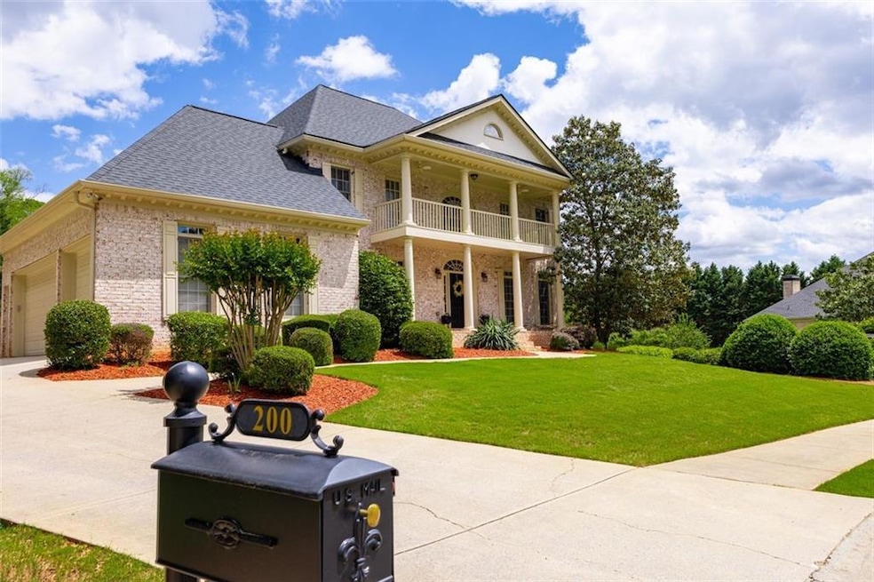 Stately brick exterior with manicured landscaping and inviting front porch. Mature trees provide shade and curb appeal.