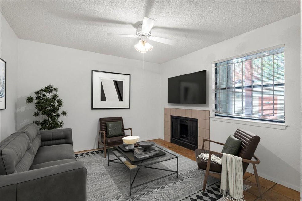 Tiled living room with a fireplace, ceiling fan, 