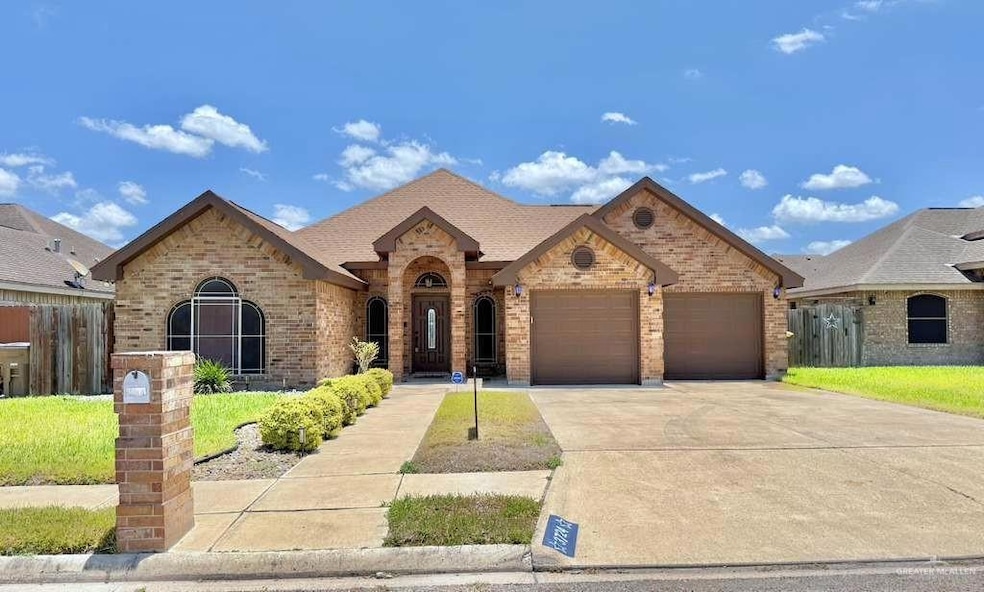 French country style house featuring brick siding, concrete driveway, and a garage