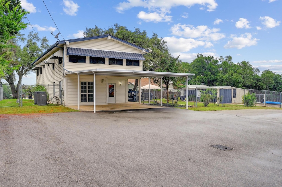 View of front facade featuring asphalt driveway, 