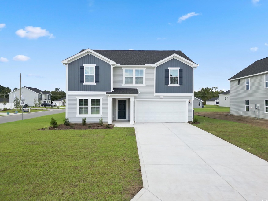 View of front of property featuring a garage and a