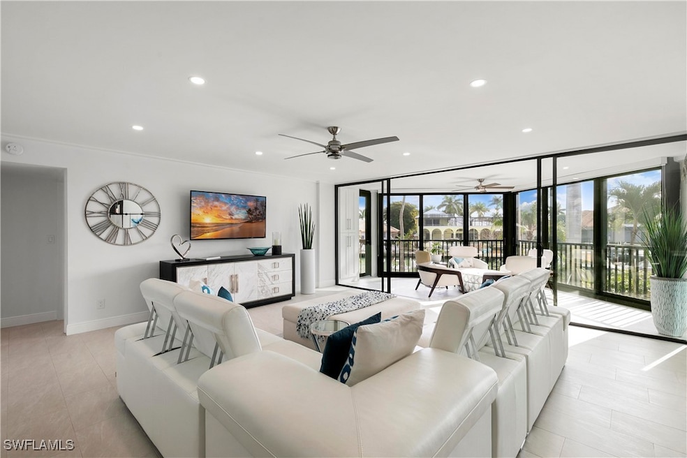 Living area featuring a wall of windows, baseboard