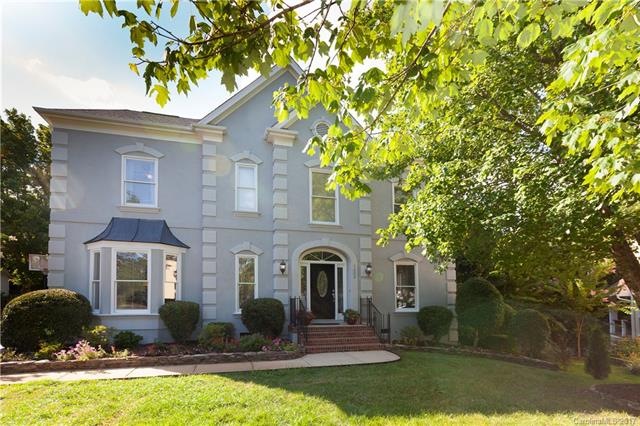 Stately hard stucco home with architectural detail