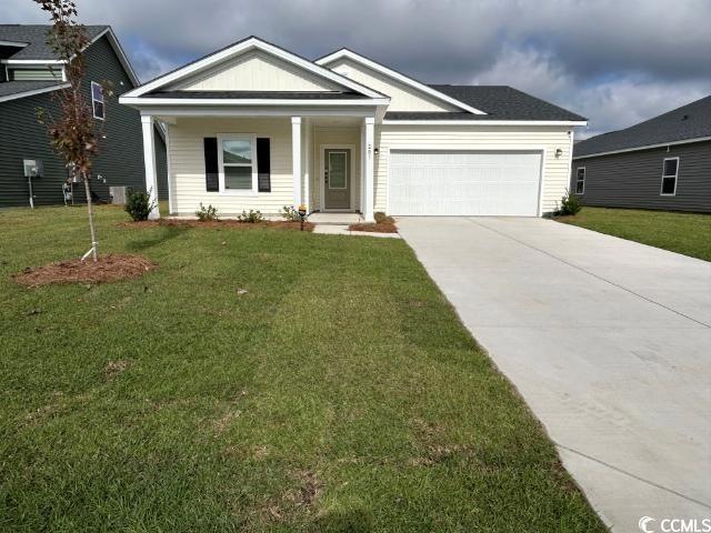 View of front of home with a garage and a front la
