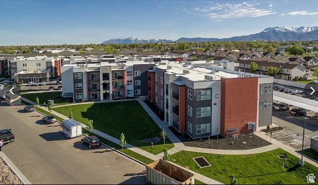 View of property with a residential view and a mountain view