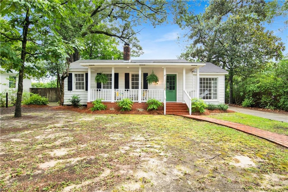 Ranch-style house featuring a porch and a chimney