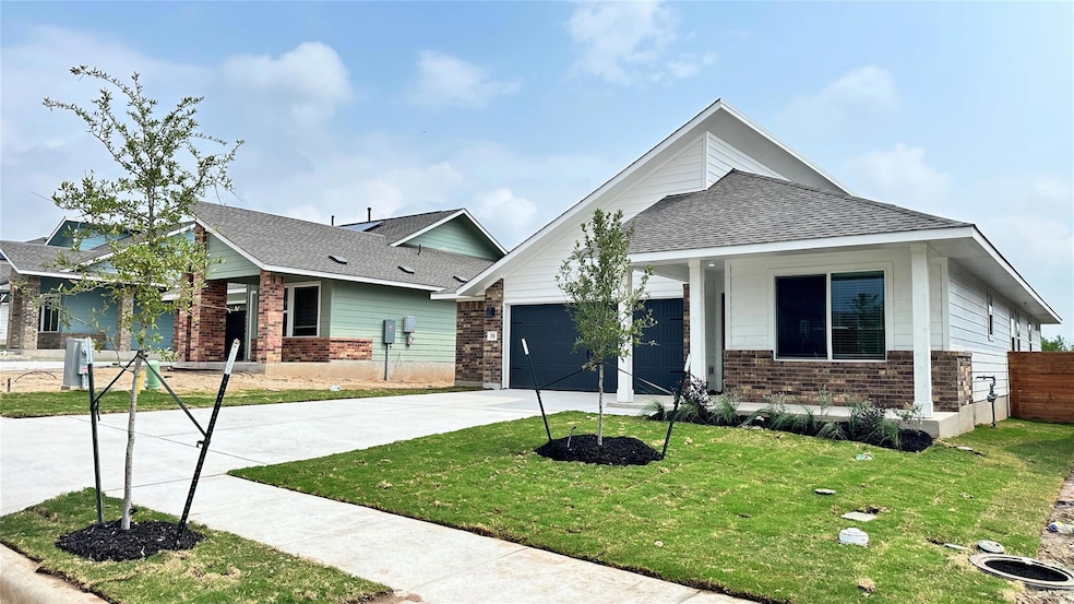 View of front facade featuring a garage, driveway