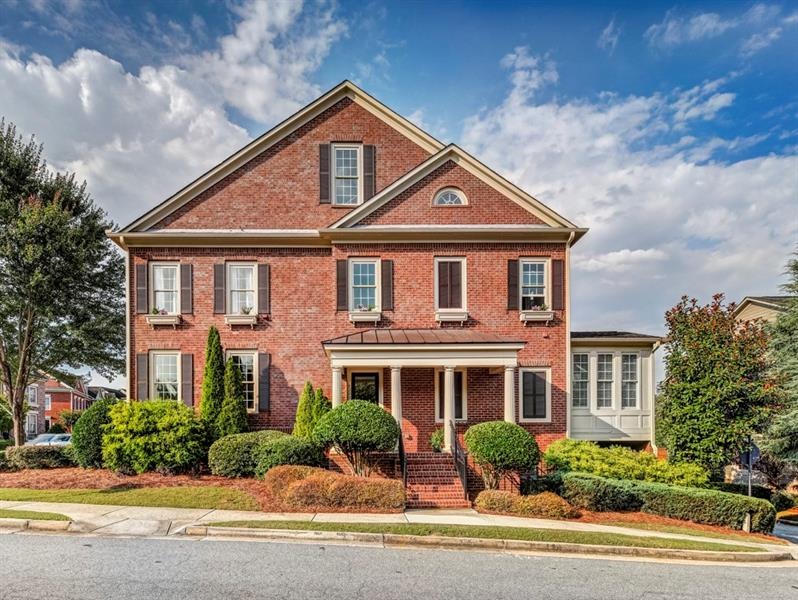 Stately end unit, all-brick townhome with front po
