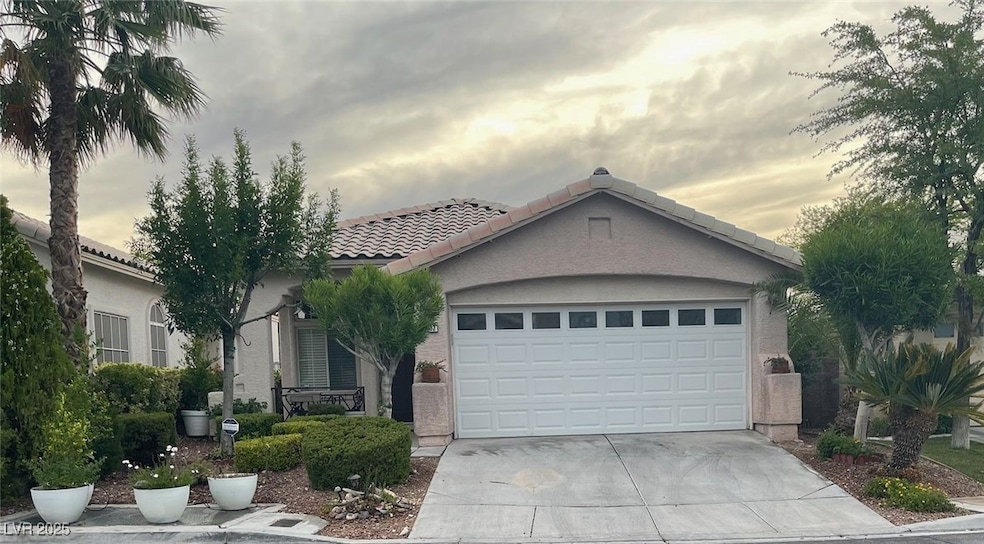 View of front of home with a tiled roof, driveway,