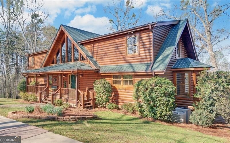 Log cabin featuring central AC, a front lawn, and 